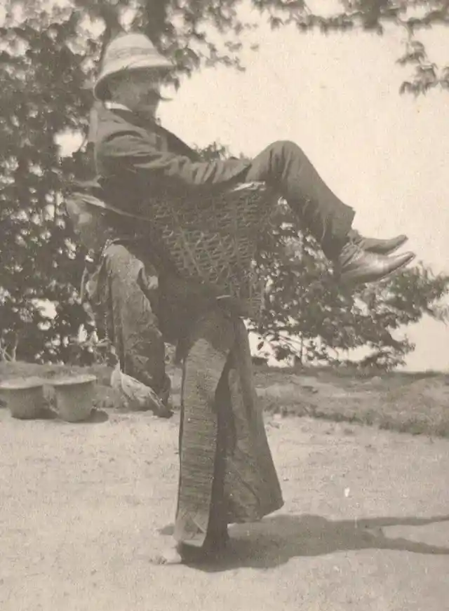 Sikkimese woman carrying a British man, West Bengal, India, circa 1900
