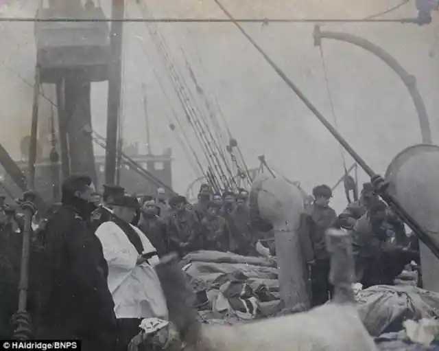 1. A priest praying over the victims of the Titanic (1912)