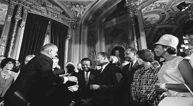 29. Lyndon B. Johnson shakes hands with Martin Luther King after the signing of the Voting Rights Act, 1965.