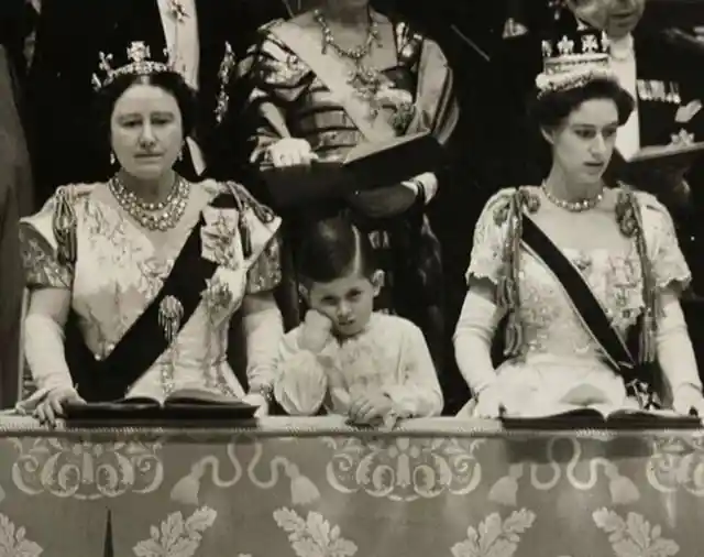 Young Prince Charles standing between his grandmother and aunt at Queen Elizabeth's coronation in 1953